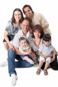 Studio Shot Of Family Group Sitting In Studio